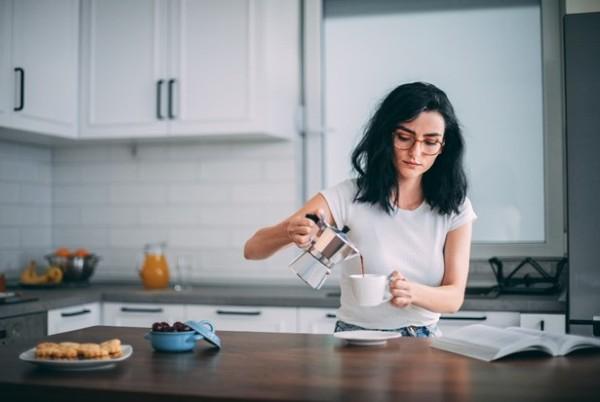 woman pours coffee french press