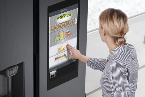 woman using a fridge with smart features