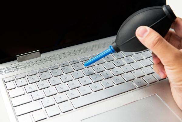 cleaning laptop keyboard with air