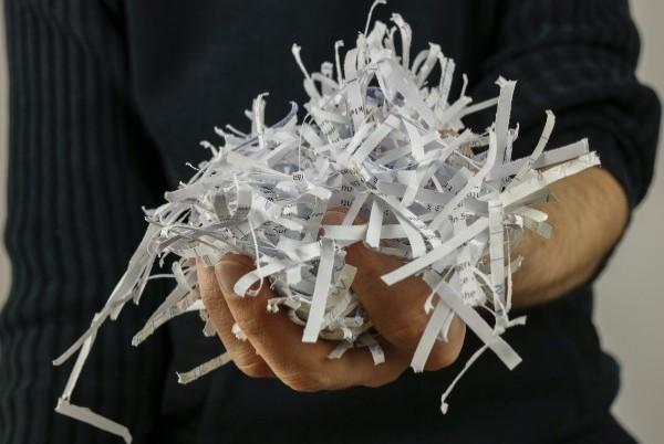 holding shredded paper