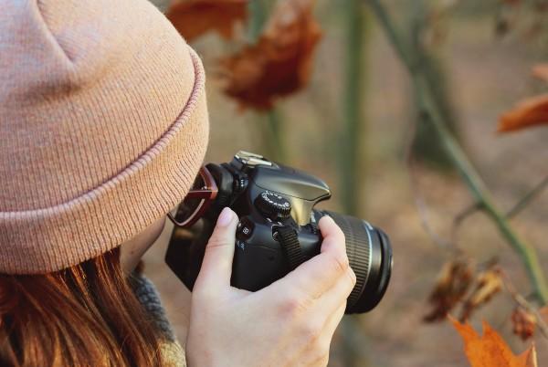 female photographer using a dslr camera