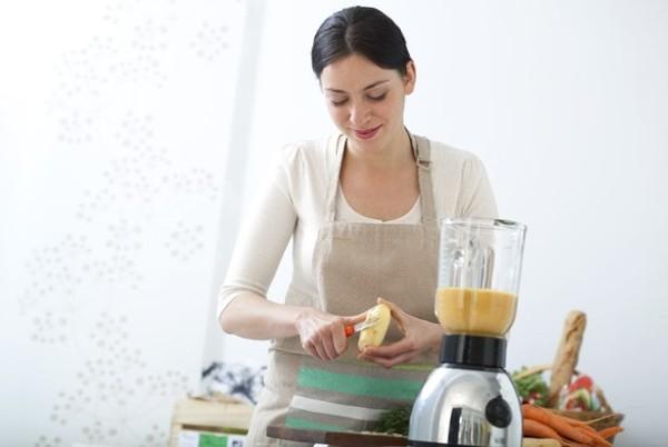 woman using a blender for soups and sauces