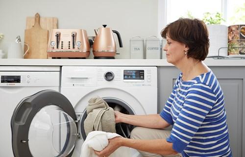 woman uses washing machine