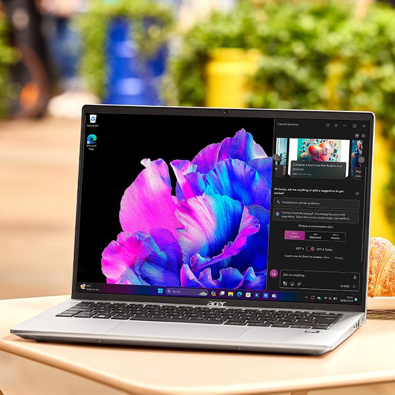 Acer Swift Go 14 laptop cafe table outside