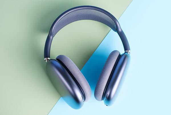 a pair of apple airpods max headphones on a blue and green background