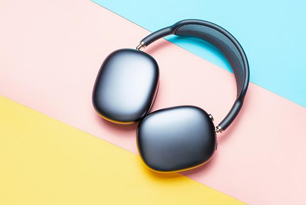 a pair of apple airpods max headphones on a colourful background