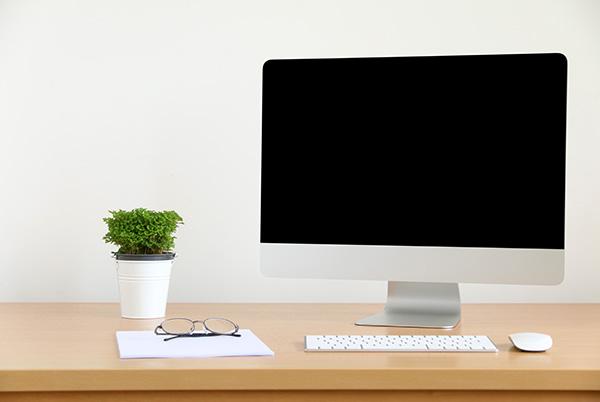 apple imac sitting on a desk next to a keyboard and mouse