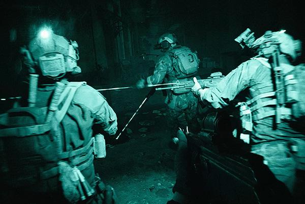 a group of soldiers in the dark with guns