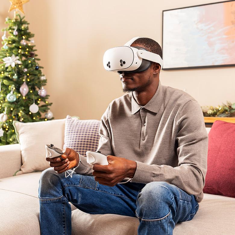 a man sitting on a couch wearing a meta quest 3s vr headset