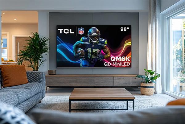 a living room with a large tcl qm6k qd mini led tv in it