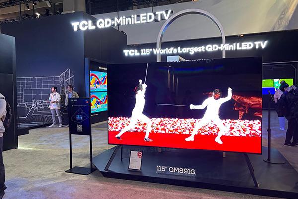 a man standing in front of a large tv with a man standing next to him at ces 2025