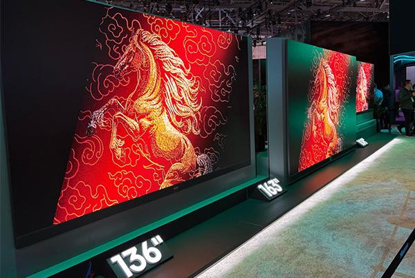 a group of people standing around a large screen with a horse on it at ces 2025
