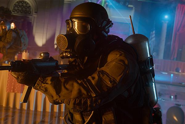 call of duty black ops 6 man in a gas mask holding a gun in a dark room