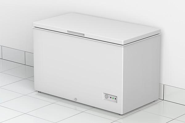 a white chest freezer sitting on a tiled floor in a room
