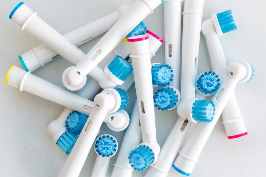 a woman and boy in a bathroom brushing teeth together