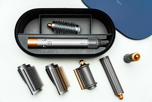 a set of dyson airwrap hair styling tools are laid out on a table