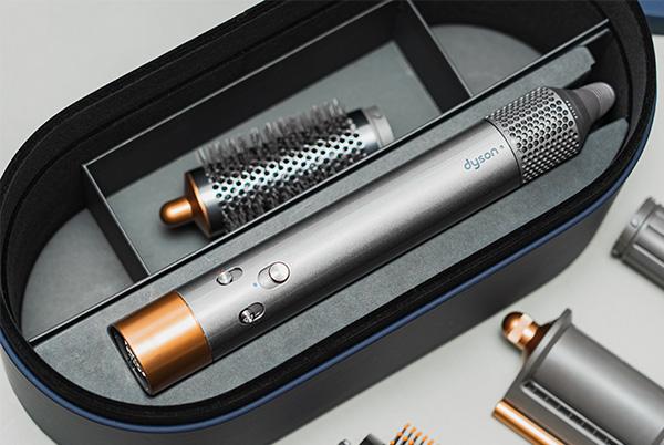 a dyson airwrap in a case with attachments