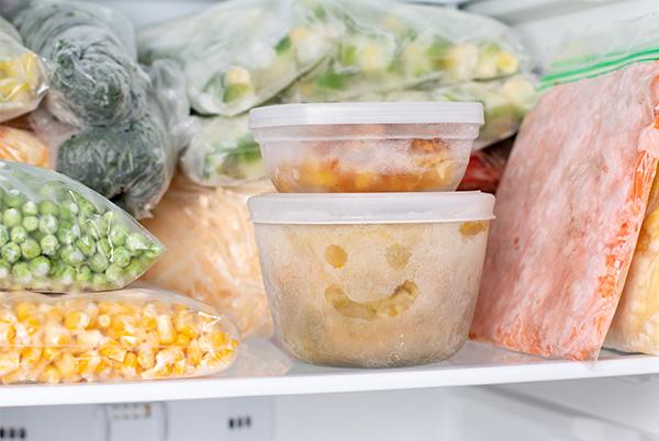 a freezer filled with containers of food