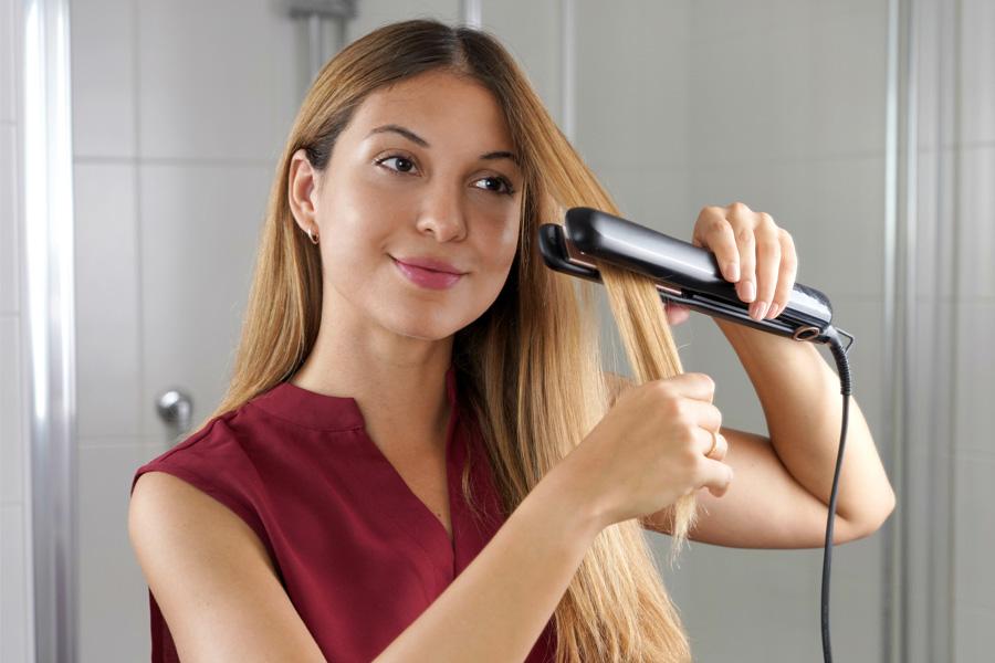 a woman is brushing her hair in front of a mirror