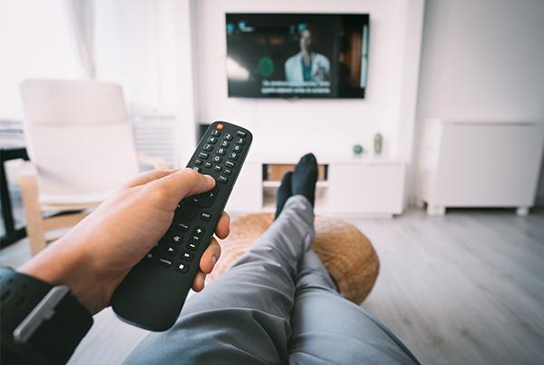 man TV remote lounge POV crossed legs