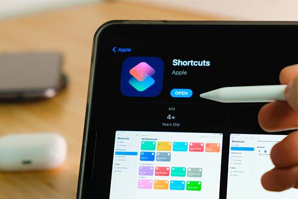 a person holding a pen over ipad with shortcuts app