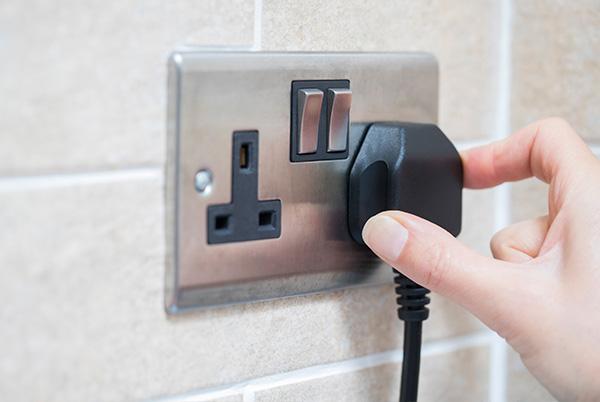 UK mains plug hand unplug