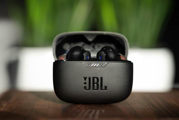 a close up of a pair of jbl earbuds sitting on a table