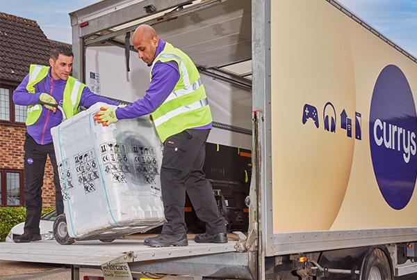two men unloading a washing machine from a moving truck