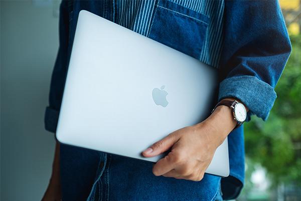 macbook under arm hand watch
