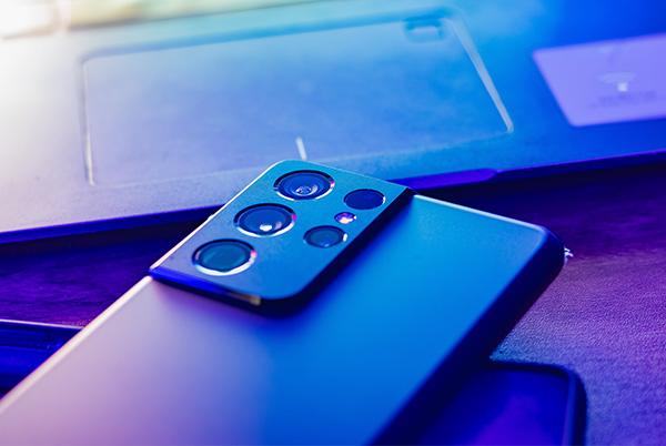 Samsung phone on desk with camera