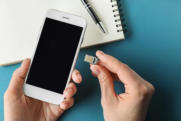 Mobile phone with SIM card being inserted