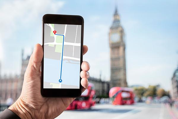Mobile phone map in man's hand Big Ben London