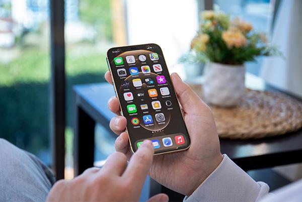 iPhone in man's hand home screen