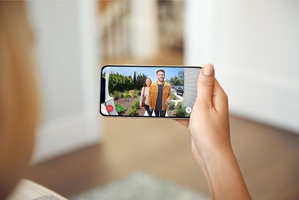 Ring smart doorbell video camera phone screen hand