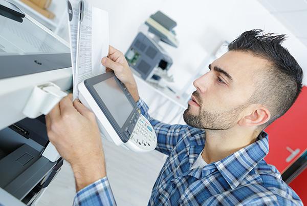 Man printer reading manual