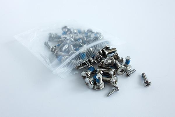 a bag of screws and nuts on a white table