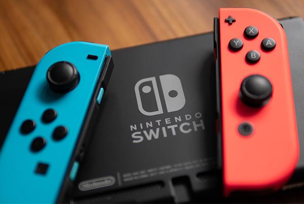 two nintendo switch controllers sitting on top of a nintendo switch