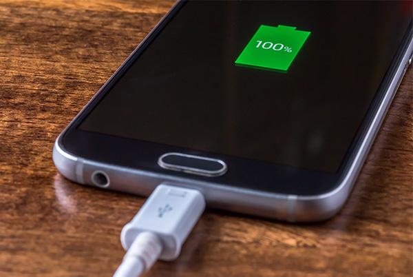 android phone on charge charging port table desk