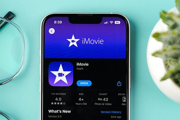 an iphone showing the imovie app on its screen