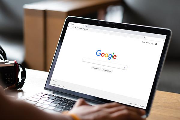 Google search on laptop screen desk