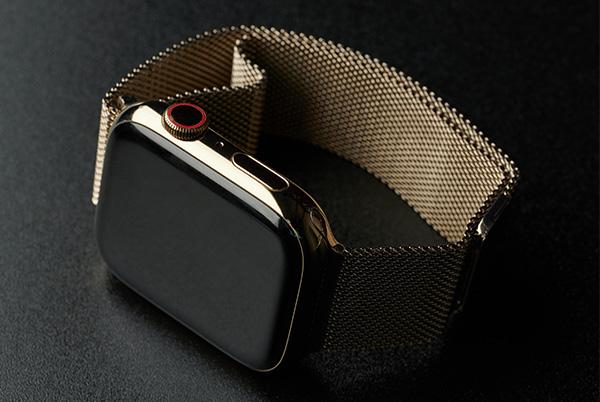 a close up of an apple watch on a black surface