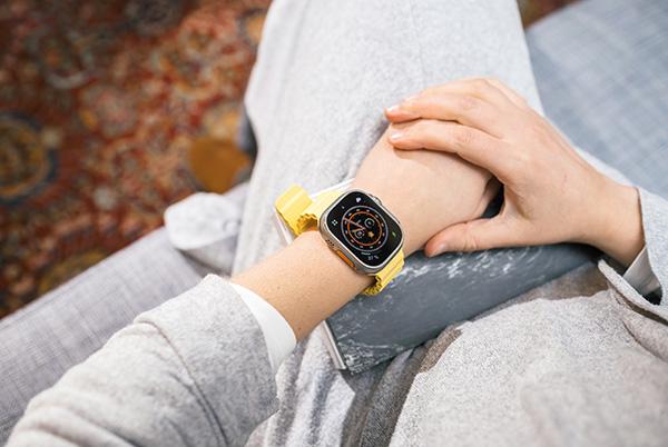 a person wearing an Apple Watch Ultra on wrist in living room