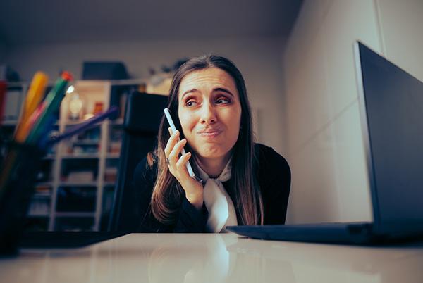 Woman annoyed phone desk