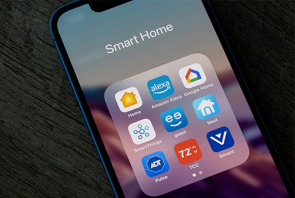 a smart phone displaying a variety of apps on a table