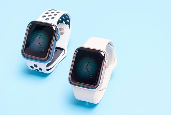 two apple watch models next to each other on blue background