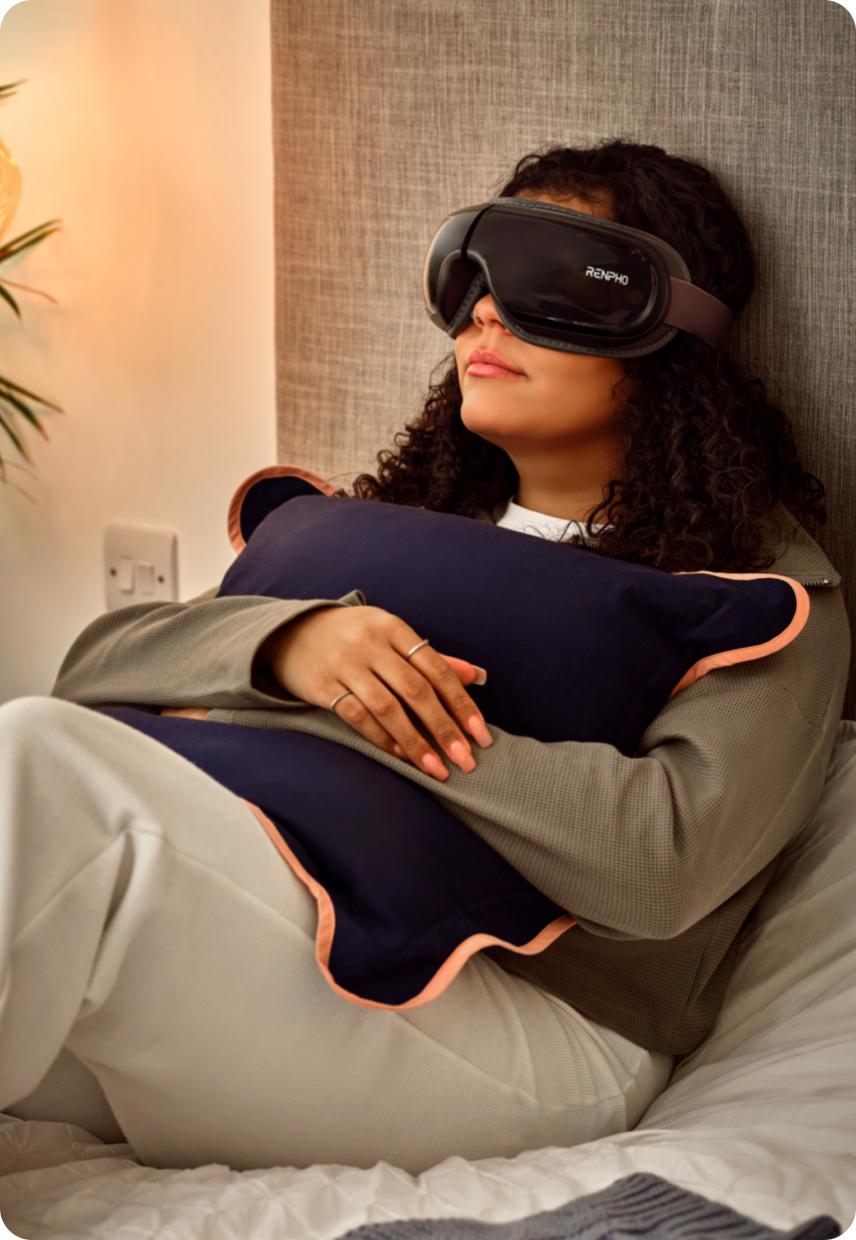 A lady on a bed with a eye mask on