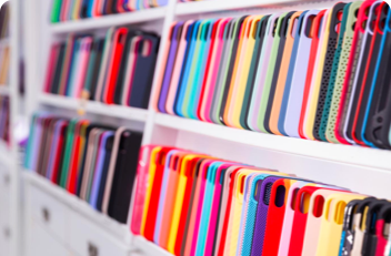 Lots of phone cases lined up on a shelf