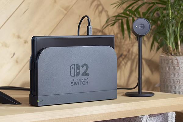 a nintendo switch 2 in its dock next to the camera accessory on a table