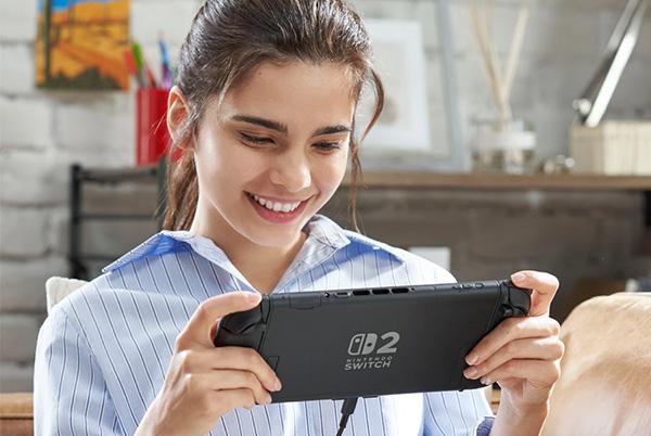 a woman smiling while holding a nintendo switch 2 in her hands