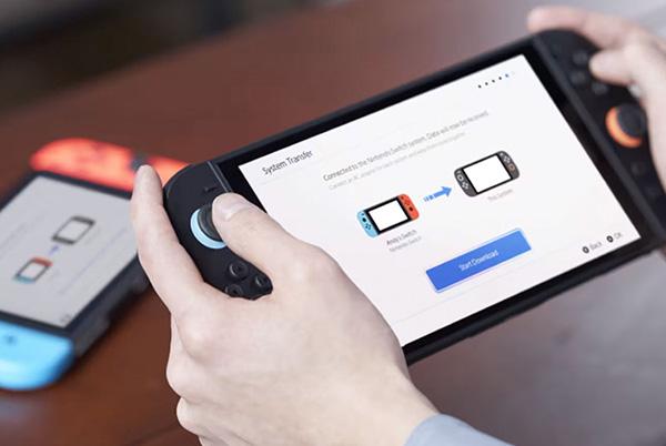 a person holding a nintendo switch 2 in their hands performing a system transfer on the screen